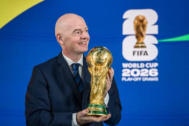 FIFA President Gianni Infantino poses with the 2026 FIFA World Cup trophy.