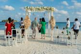 Surrounded by the Nova wedding party my wife and I renewed our vows on the white sands of Vakarufalhi.