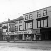 Kirkgate in October 1948. This view shows shops at numbers 98 to 101. Number 98 W. & G. Scott Provision Merchant, numbers 99 to 101 Quality Furnishers Ltd. Advertisement in window. Cobbled road with tram lines. The block was between the Fox and Grapes Yard and Crown Court.