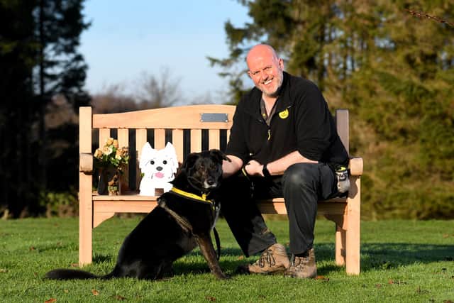 Dog Welfare Assistant Kevin Johnson is pictured with dog Opie.