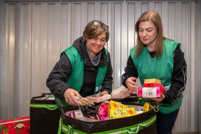 Volunteers Kirsty Groves and Lianne Hare from company TransUnion sorting some of the gifts which have been donated so far this year.