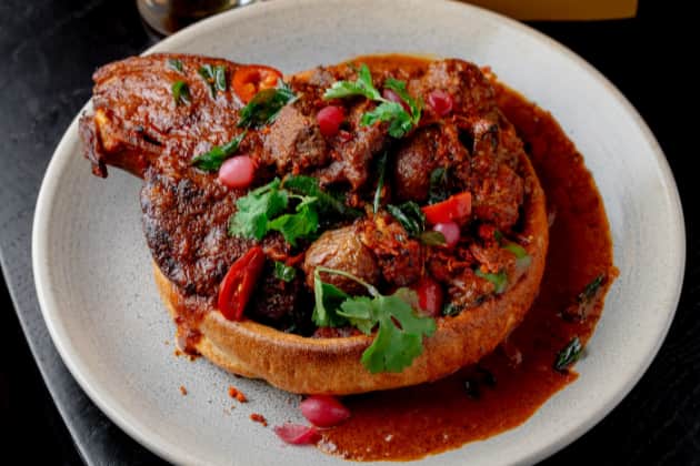 The Indian 'ultra roast' contains a braised and roasted T‑bone steak, Hasselback potatoes and seasonal masala vegetables, served - naturally - in a Yorkshire pudding.