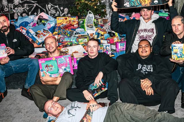 Hardcore music fans brought over 600 toys to a gig at Boom Leeds to be donated to the Child Friendly Leeds gift appeal. Organiser Arran Gordon pictured fourth from the right.
