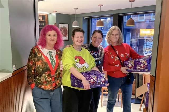 Staff from Child Friendly Leeds and Foster4Leeds pictured at Hyde Park Picture House with selection boxes donated by VINCI Building in Leeds