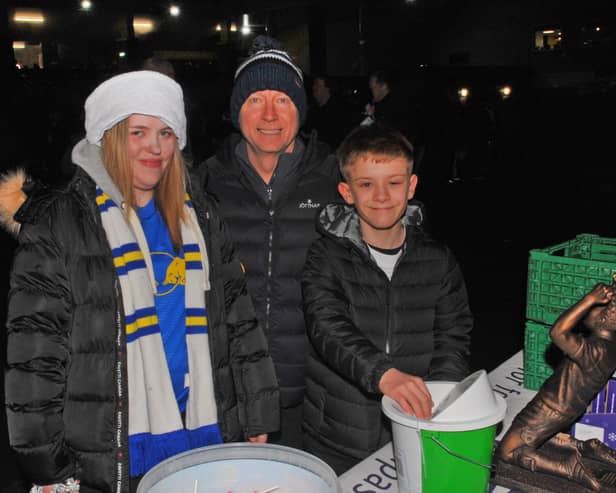 Paul Smith, of Rothwell, and his children Ellie and Theo donate to the foodbank at Elland Road