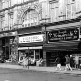 Kirkgate Market from Vicar Lane in May 1984. On the left is the Market Hall entrance, then Cut Price Records, no.13 Market Buildings, Economic Woollen Company, fabrics, no.14 and Joseph Hemsworth, jeweller, no.15.