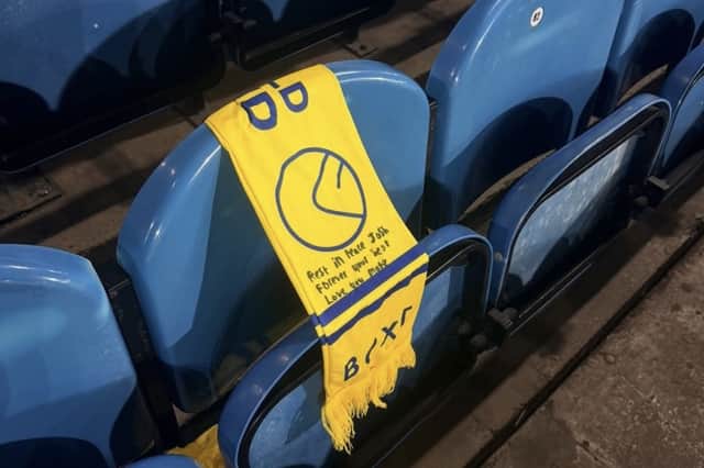 Friends of Joshua Pick laid a scarf on his season-ticket seat.