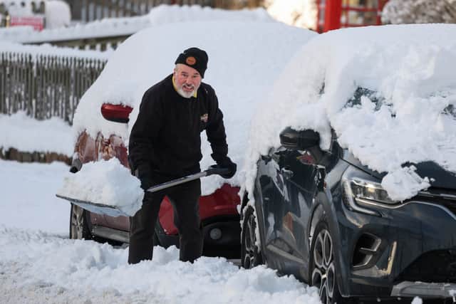 A man shovels snow as an 'amber' snow warning was issued on January 2 in Scotland. Cold Weather Payments offer £25 support during prolonged periods of freezing weather (Photo: Jeff J Mitchell/Getty Images)