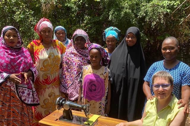 Sara Peatfield meeting the sewing groups who produce reusable sanitary pads for girls to keep them in school when menstruating . The women are also taught to make clothes to generate a family income.