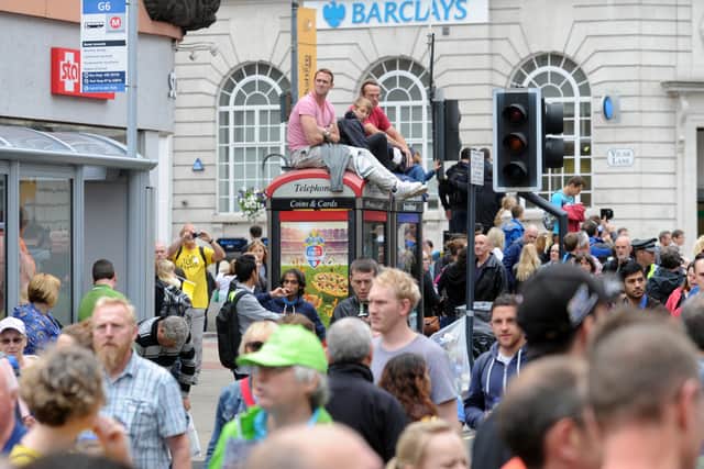 Fans watch the cyclists down the Headrow at the start of the Tour De France in 2014.
