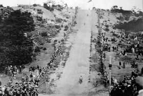 Motorcyclists tackle the hill climb.