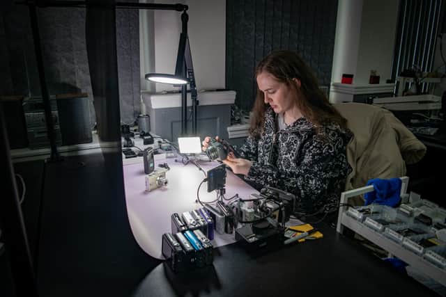 Danielle cleans and restores cameras before they go on sale.