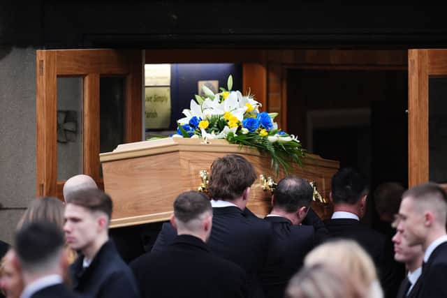 The casket is carried into the church before the funeral service for Terry Yorath.