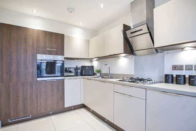 Modern kitchen with bay window, breakfast bar and integrated appliance