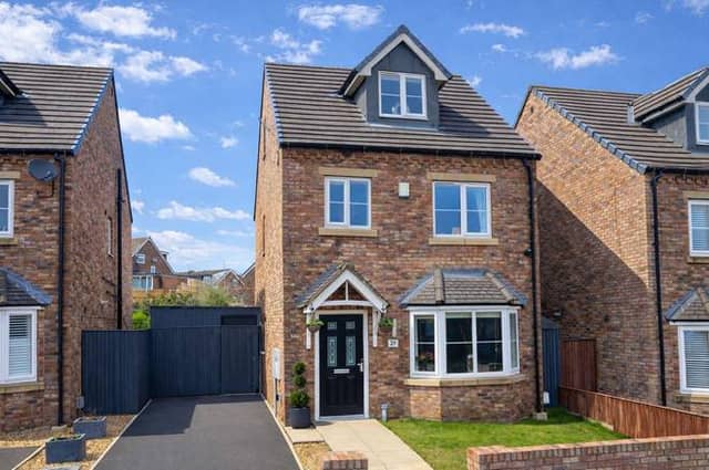 Front elevation showing detached family home and driveway parking