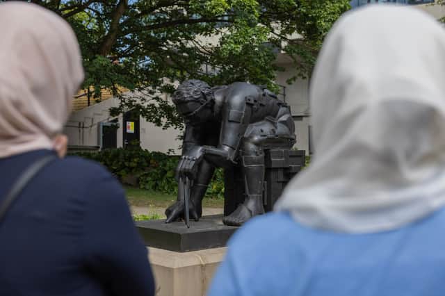 Participants in Leeds University Library Galleries & Cultural Collections’ workshops with Leeds Asylum Seekers’ Support Network discuss Eduardo Paolozzi’s 1989 sculpture Master of the Universe, on the campus Public Art Trail.  
