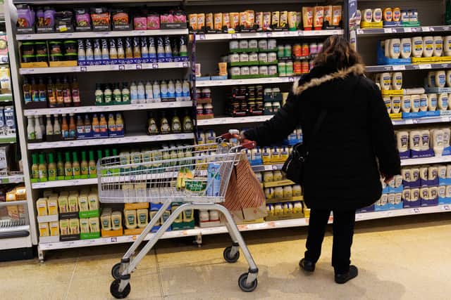A customer looks at goods on a shelf in a supermarket. Grocery price inflation eased to 4% in January, its lowest level since April, offering slight relief for households (Photo: Dan Kitwood/Getty Images)