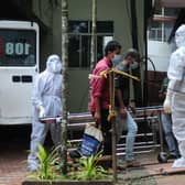 Health workers wearing protective gear move people who have been in contact with a person infected with the Nipah virus to an isolation centre.