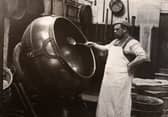A man in an apron panning chocolate at Rowntree Cocoa Works, York, in 1900