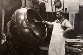 A man in an apron panning chocolate at Rowntree Cocoa Works, York, in 1900