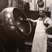A man in an apron panning chocolate at Rowntree Cocoa Works, York, in 1900