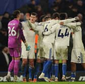 Leeds United players celebrate a hard-earned point at Chelsea.