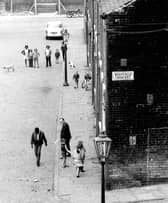 Rillbank Street where several people can be seen, including children playing, at the junction with Westfield Crescent. The photographer, Eric Jacquier, was standing on one of several flights of steps leading down from Rosebank Road.