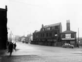 York Road in November 1938. In focus is the junction with Marsh Lane, view of derelict property, shop on the right has notice of transfer to 11 Burmantoft Street