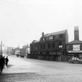 York Road in November 1938. In focus is the junction with Marsh Lane, view of derelict property, shop on the right has notice of transfer to 11 Burmantoft Street