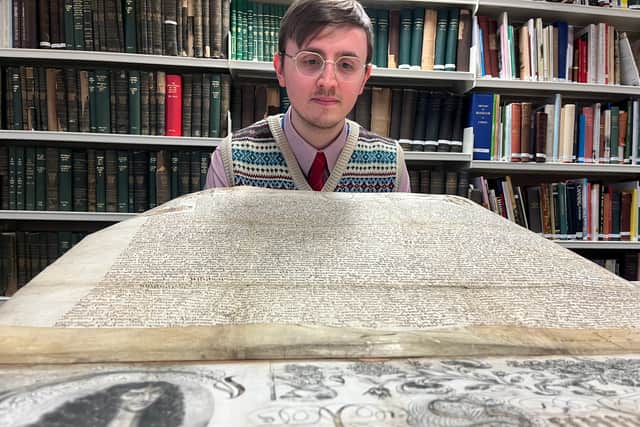 Alex Pearson, archives assistant with West Yorkshire Archive Service, pictured with both the 1646 and 1661 charters.