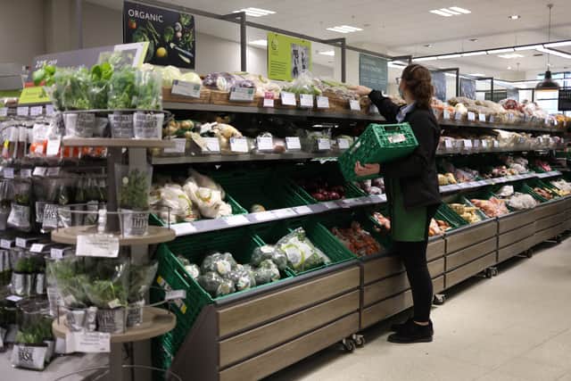 An employee stacks shelves at a Waitrose supermarket. John Lewis Partnership is investing £108 million in a 6.9% pay rise for shop workers (Photo: HOLLIE ADAMS/AFP via Getty Images)