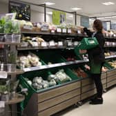 An employee stacks shelves at a Waitrose supermarket. John Lewis Partnership is investing £108 million in a 6.9% pay rise for shop workers (Photo: HOLLIE ADAMS/AFP via Getty Images)