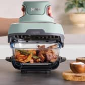 The Ninja CRISPi Portable Air Fryer in Sage cooks directly in a clear glass container, combining compact design with powerful air frying performance