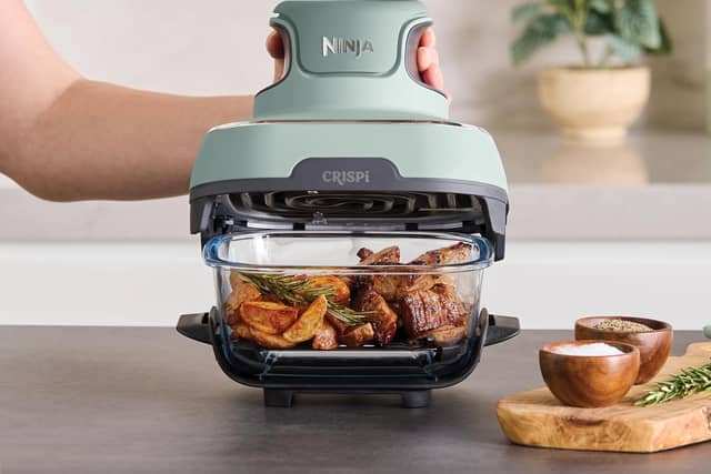 The Ninja CRISPi Portable Air Fryer in Sage cooks directly in a clear glass container, combining compact design with powerful air frying performance