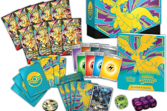 The set contains a full-art promo card, nine booster packs, and premium accessories
