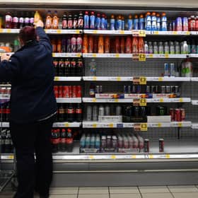 An employee stocks shelves at a Tesco supermarket. The retailer is increasing hourly pay for store and warehouse staff by 5.1% from March 29 (Photo: JUSTIN TALLIS/AFP via Getty Images)