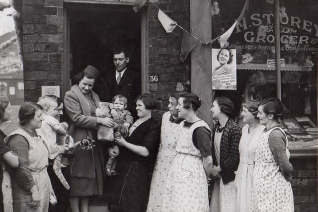 Doris pictured with family and friends in front of a shop in 1938.