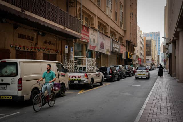 A cyclist rides past a deserted street at a market place in Dubai.