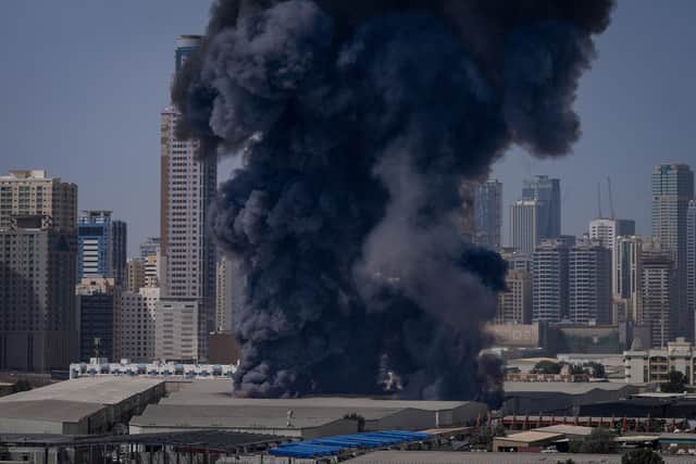 A black plume of smoke rises from a warehouse at the industrial area of Sharjah City in the United Arab Emirates following reports of Iranian strikes in Dubai.