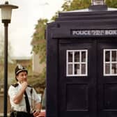 A perplexed PC John Knowles is pictured looking at the latest edition to Wetherby Police Station -  a replica police box, dubbed the 'Tardis'.