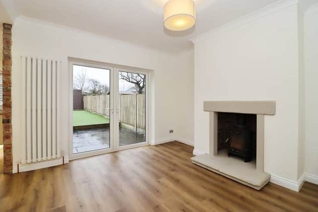 A spacious lounge centred around a charming fireplace creates the perfect spot for relaxed evenings