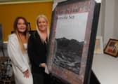 Becky and Shelley Joyce, Co-Founders of Homeless Street Angels, with the  signed Damien Hirst poster up for auction at their art exhibition and auction on March 14.