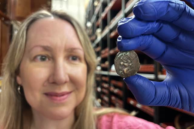 Kat Baxter, curator of archaeology and numismatics at Leeds Museums and Galleries, pictured with the ancient coin.