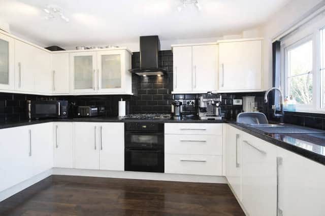The contemporary fitted kitchen flows into a spacious dining area, creating a practical setting for family meals and entertaining