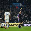 BACK IN THE MIDDLE: Referee Thomas Bramall, pictured booking Marc Guehi in December's clash between Leeds United and Crystal Palace at Elland Road.