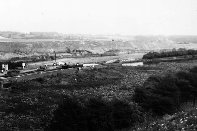 An undated photo of a boat passing through Fishpond Lock, on the Aire & Calder Navigation. The image was taken just north of the railway line and Waterloo Colliery sidings, and looks north.