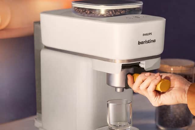 Just slide the Portafilter over to the right, and the machine does everything else for you