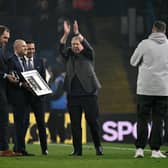 Leeds United legend Mick Jones applauds fans.