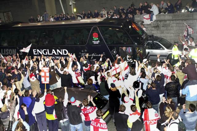 Fans surrounded the coach carrying the England rugby team at Heathrow after they arrived on a plane from Sydney.