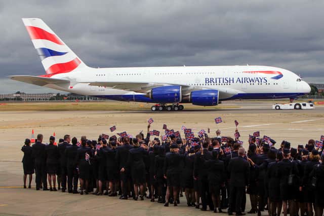 British Airways staff greet the Airbus A380, the world's largest commercial jet.
